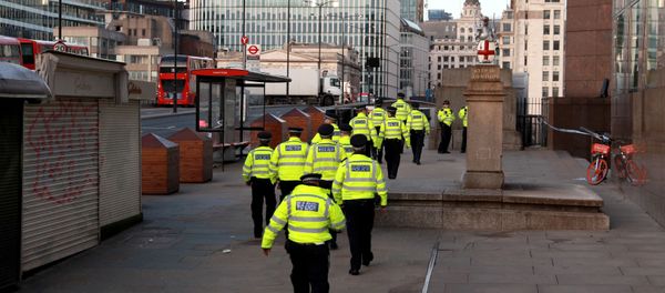 Police officers walk near the scene of a stabbing on London Bridge - Sputnik International