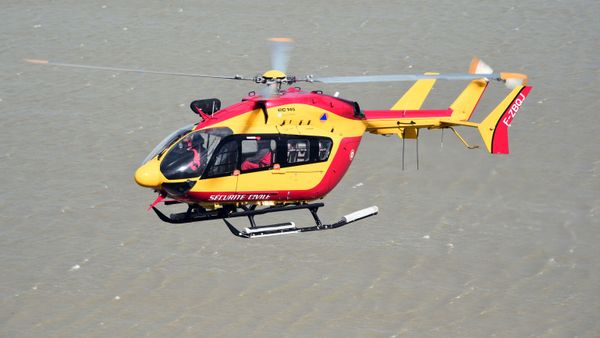 In this file photo taken on May 05, 2015 A French Civilian Security EC145 helicopter flies next to Mont-Saint-Michel in Normandy during a large air evacuation drill, in order to test coordination of air assets in the event of a potential crisis scenario at the site. - Three emergency workers were killed in a helicopter crash near Marseille while on a rescue mission in southern France where floods have left two dead, officials said December 2, 2019. - Sputnik International