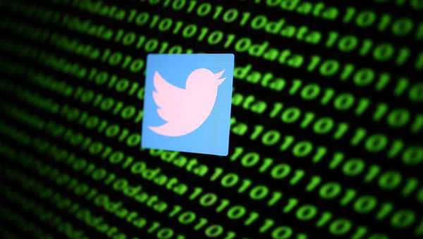 The Twitter logo and binary cyber codes are seen in this 26 November 2019 illustration. - Sputnik International