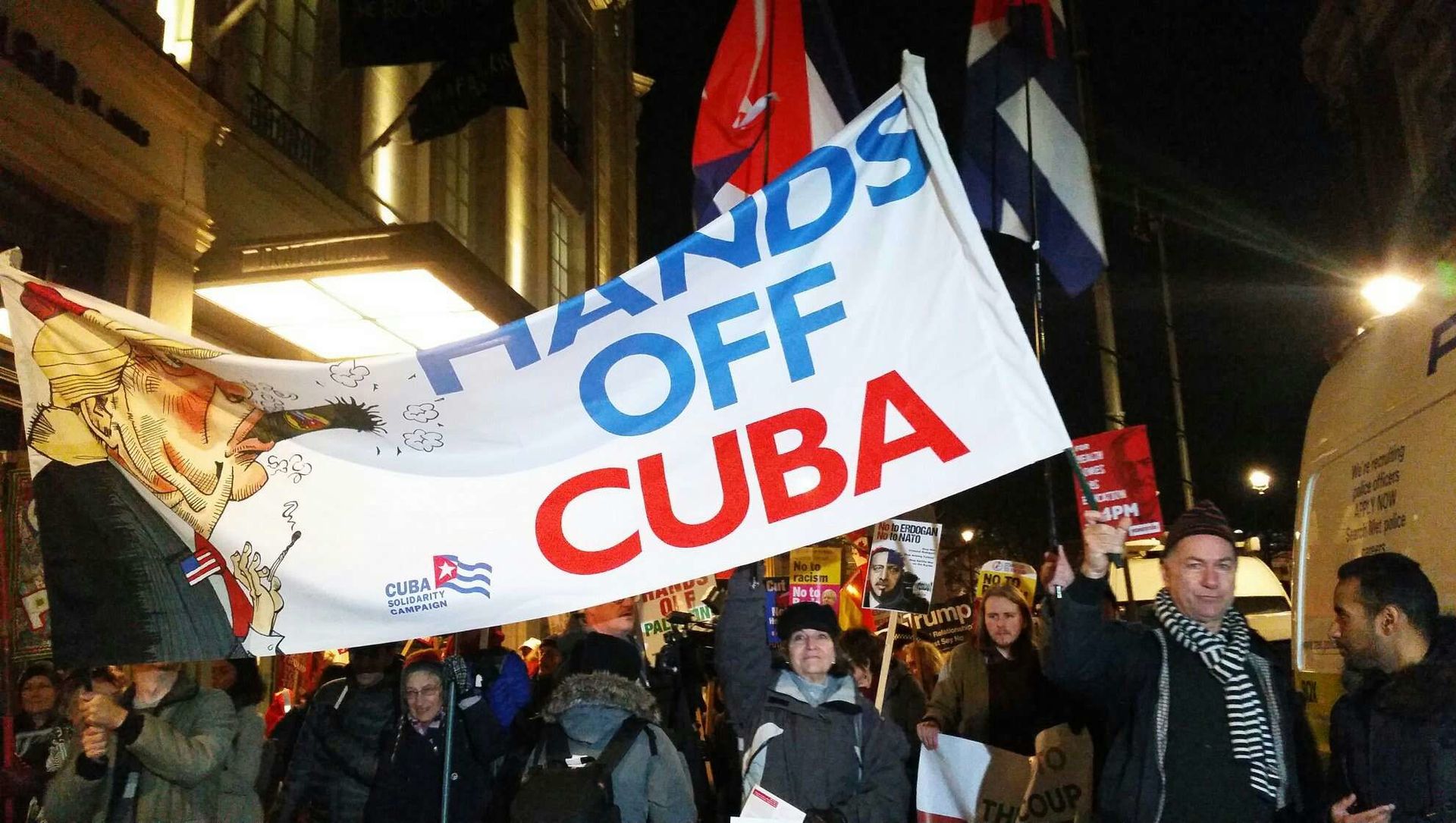 Rob Miller of Cuba Solidarity Campaign holds banner as anti-NATO demonstration moves from Trafalgar Sq to Buckingham Palace Rob Miller of Cuba Solidarity Campaign holds banner as anti-NATO demonstration moves from Trafalgar Sq to Buckingham Palace - Sputnik International, 1920, 23.03.2021
