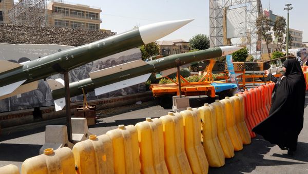 An Iranian woman looks at Taer-2 missile during a street exhibition by Iran's army and paramilitary Revolutionary Guard celebrating  Defence Week marking the 39th anniversary of the start of 1980-88 Iran-Iraq war, at the Baharestan Square in Tehran, on September 26, 2019 - Sputnik International