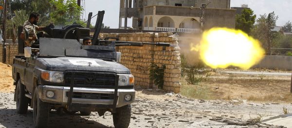 A fighter loyal to the internationally recognised Libyan Government of National Accord (GNA) fires a truck-mounted gun during clashes with forces loyal to strongman Khalifa Haftar in the capital Tripoli's suburb of Ain Zara, on September 7, 2019. A fighter loyal to the internationally recognised Libyan Government of National Accord (GNA) fires a truck-mounted gun during clashes with forces loyal to strongman Khalifa Haftar in the capital Tripoli's suburb of Ain Zara, on September 7, 2019. - Sputnik International