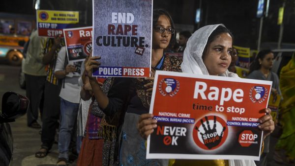 Demonstrators hold placards to protest against sexual assaults on women, following the alleged gang-rape and murder of a 27-year-old veterinarian in Hyderabad and other recent sexual assaults, during a march in Kolkata on December 4, 2019 - Sputnik International