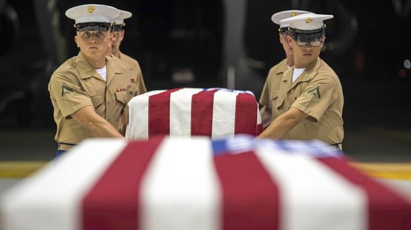 In this Wednesday, 17 July 2019 photo, US Marines carry transfer cases holding the possible remains of unidentified service members lost in the Battle of Tarawa during World War II, during what is known as an honourable carry conducted by the Defense POW/MIA Accounting Agency (DPAA), in a hangar at the Joint Base Pearl Harbor-Hickam in Hawaii. - Sputnik International