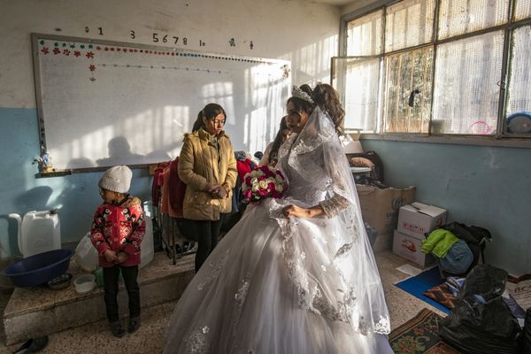Hanan, a displaced Syrian woman wears her wedding dress at her temporary home, a school building transformed into a makeshift shelter, before being wed to Mohammad in the northern Syrian city of Hasakeh on December 1, 2019. Hanan and Mohammad fled with their families from the northeastern town of Ras al-Ain following the Turkish offensive against the Kurdish-dominated region, were wedded after being in love for three years. Hanan, a displaced Syrian woman wears her wedding dress at her temporary home, a school building transformed into a makeshift shelter, before being wed to Mohammad in the northern Syrian city of Hasakeh on December 1, 2019. Hanan and Mohammad fled with their families from the northeastern town of Ras al-Ain following the Turkish offensive against the Kurdish-dominated region, were wedded after being in love for three years. - Sputnik International