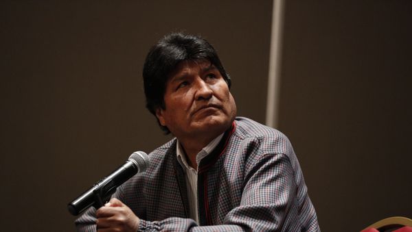 Former Bolivian President Evo Morales, who was granted asylum in Mexico, looks up toward a video playing on a screen during a press conference in Mexico City, Wednesday, Nov. 20, 2019.  - Sputnik International