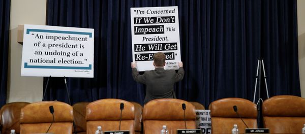 A Republican staff member adjusts a sign behind Republican seats on the dais at the first House Judiciary Committee hearing on the impeachment inquiry into U.S. President Donald Trump A Republican staff member adjusts a sign behind Republican seats on the dais at the first House Judiciary Committee hearing on the impeachment inquiry into U.S. President Donald Trump - Sputnik International
