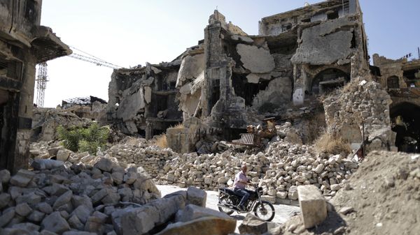 A man in the rubble of the old city of Aleppo - Sputnik International
