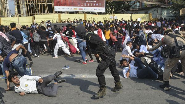 Security personnel use batons to disperse students protesting against the governments Citizenship Amendment Bill (CAB), in Guwahati on December 11, 2019 - Sputnik International