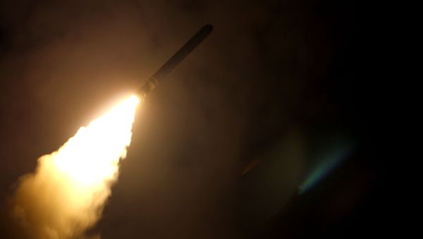 In this image released by the US Department of Defense the guided-missile cruiser USS Monterey fires a Tomahawk land attack missile on April 14, 2018 - Sputnik International