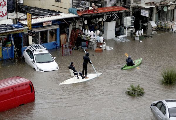 Lebanese men use a paddle board and canoe as means of transportation on a flooded road due to heavy rain, at the southern entrance of the capital Beirut on December 9, 2019 Lebanese men use a paddle board and canoe as means of transportation on a flooded road due to heavy rain, at the southern entrance of the capital Beirut on December 9, 2019 - Sputnik International