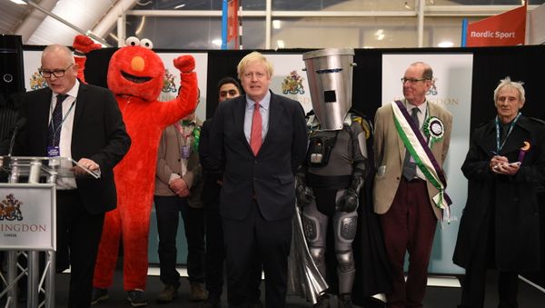 Britain's Prime Minister and Conservative leader Boris Johnson (C) reacts as the results are read out for the race to be MP for Uxbridge and Ruislip South at the count centre in Uxbridge, west London, on December 13, 2019 after votes were counted as part of the UK general election. - Sputnik International