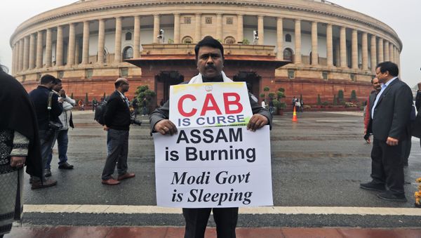 An Indian Lawmaker from Congress party, Abdul Khaleque holds a banner in protest against the Citizenship (Amendment) Bill at the Parliament House, in New Delhi, India, Friday, Dec. 13, 2019 - Sputnik International