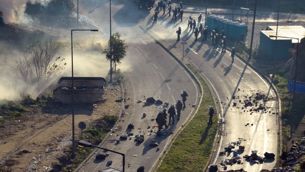 Smoke from tear gas canisters rises next to a camp for refugees and migrants, during clashes between migrants and riot police, on the island of Samos, Greece, December 19, 2019. - Sputnik International