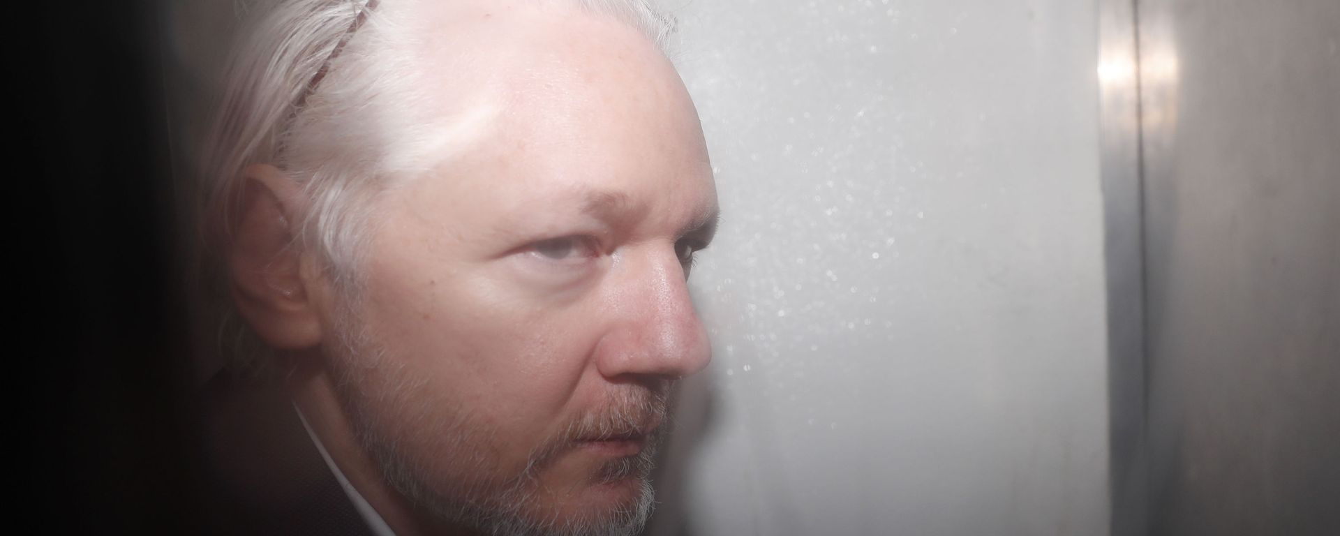 WikiLeaks founder Julian Assange is seen in a prison van traveling to Westminster Magistrates Court in London, Friday, Dec. 20, 2019. Assange is expected to appear in person before Westminster Magistrates in a private hearing related to a Spanish criminal case about alleged surveillance at the Ecuador embassy WikiLeaks founder Julian Assange is seen in a prison van traveling to Westminster Magistrates Court in London, Friday, Dec. 20, 2019. Assange is expected to appear in person before Westminster Magistrates in a private hearing related to a Spanish criminal case about alleged surveillance at the Ecuador embassy - Sputnik International, 1920, 13.12.2022