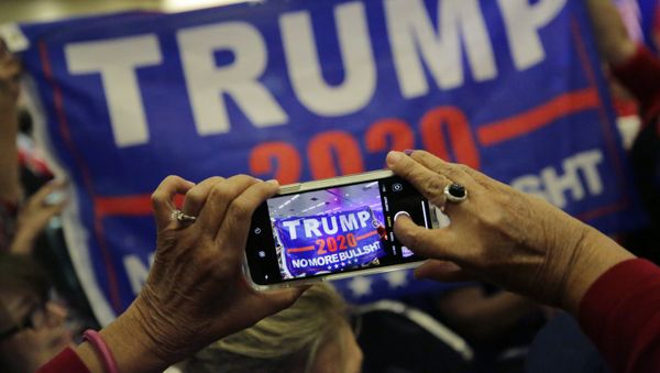Supporters of President Donald Trump photograph a banner before a panel discussion with Donald Trump, Jr., Trump campaign senior adviser Kimberly Guilfoyle, and Trump campaign manager Brad Parscale, Tuesday, 15 October 2019, in San Antonio. - Sputnik International