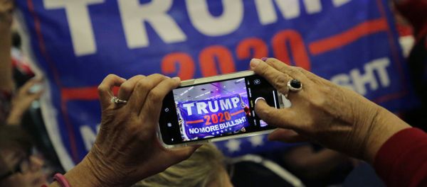 Supporters of President Donald Trump photograph a banner before a panel discussion with Donald Trump, Jr., Trump campaign senior adviser Kimberly Guilfoyle, and Trump campaign manager Brad Parscale, Tuesday, Oct. 15, 2019, in San Antonio. Supporters of President Donald Trump photograph a banner before a panel discussion with Donald Trump, Jr., Trump campaign senior adviser Kimberly Guilfoyle, and Trump campaign manager Brad Parscale, Tuesday, Oct. 15, 2019, in San Antonio. - Sputnik International