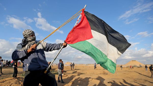 A Palestinian demonstrator uses a sling during an anti-Israel protest at the Israel-Gaza border fence, in the southern Gaza Strip December 6, 2019. A Palestinian demonstrator uses a sling during an anti-Israel protest at the Israel-Gaza border fence, in the southern Gaza Strip December 6, 2019. - Sputnik International