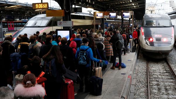 Commuters walk on a platform at Gare de l'Est train station during a strike by all unions of French SNCF and the Paris transport network (RATP) in Paris as French transportation workers' strike continues for a 19th day against pension reform plans in France, December 23, 2019 - Sputnik International