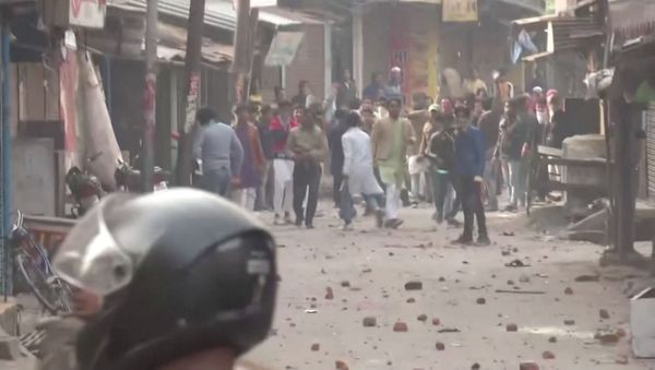 Protesters pelt stones at police personnel during clashes over citizenship law in Gorakhpur, Uttar Pradesh, India December 20, 2019 in this still image taken from a video - Sputnik International