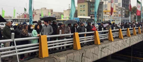 People stands in the street to show their protest against increased gas price in Tehran, Iran November 16, 2019 - Sputnik International