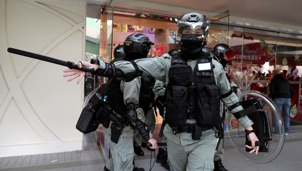 A riot police officer gestures as anti-government demonstrator take part in a protest in Sheung Shui shopping mall in Hong Kong, China, December 28, 2019 - Sputnik International
