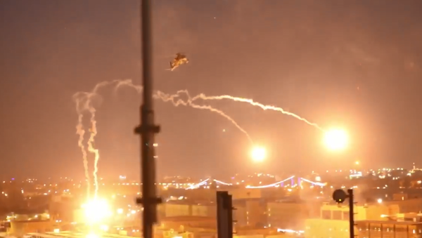 A US Apache attack helicopter fires flares while on patrol in Baghdad, Iraq, following an attempt by protesters to gain entry to the US embassy - Sputnik International