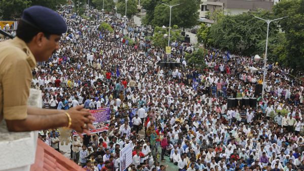 A policeman keeps vigil as hundreds of members of India's low-caste Dalit community gather for a rally to protest against the attack on their community members in Ahmadabad, India, Sunday, July 31, 2016. - Sputnik International