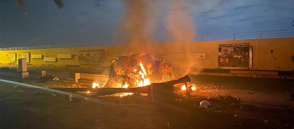 A picture shows a destroyed vehicle on fire following a US strike on January 3, 2020 on Baghdad international airport road in which top Iranian commander Qasem Soleimani was killed  - Sputnik International