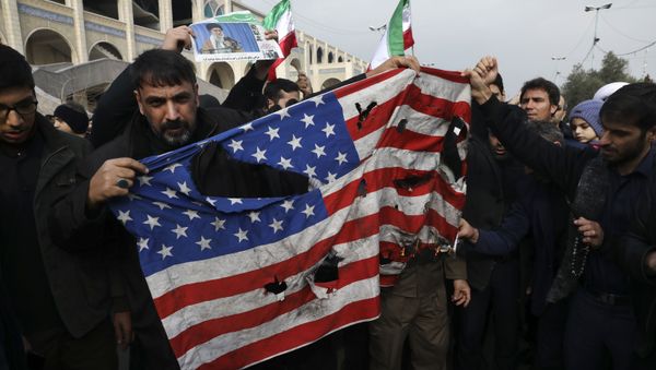 Protesters burn a U.S. flag during a demonstration over the U.S. airstrike in Iraq Protesters burn a U.S. flag during a demonstration over the U.S. airstrike in Iraq - Sputnik International