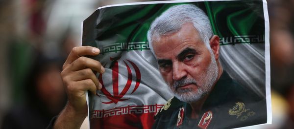 An Iranian holds a picture of late General Qassem Soleimani, head of the elite Quds Force, who was killed in an air strike at Baghdad airport, as people gather to mourn him in Tehran, Iran January 4, 2020. An Iranian holds a picture of late General Qassem Soleimani, head of the elite Quds Force, who was killed in an air strike at Baghdad airport, as people gather to mourn him in Tehran, Iran January 4, 2020. - Sputnik International