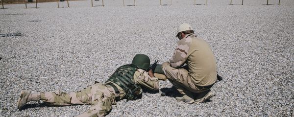 In this March 9, 2016 file image, a Dutch army trainer, right, helps a Kurdish Peshmerga soldier during a military training session at a shooting range, at Bnaslawa Military Base in Irbil, northern Iraq.  - Sputnik International
