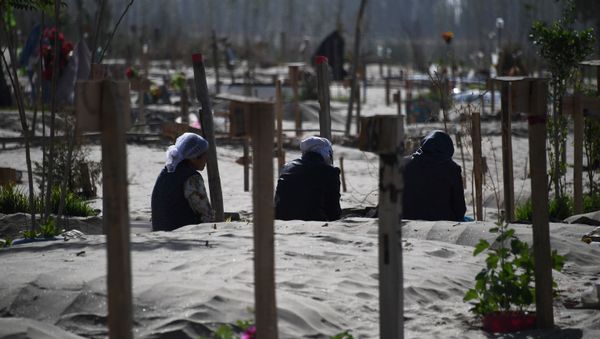 This photo taken on May 31, 2019 shows Uighur women praying in a graveyard on the outskirts of Hotan in China's northwest Xinjiang region - Sputnik International