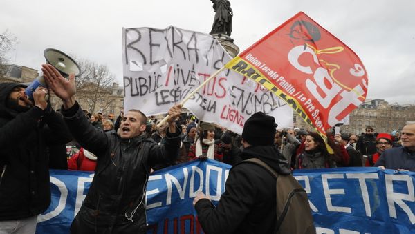 Protestors hold banners during a demonstration called by French national trade union General Confederation of Labour (CGT) against the pension reform on January 4, 2020, on the Place de la Republique in Paris - Sputnik International