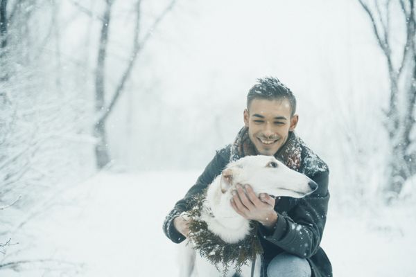 Smiling man with a white dog with winter forest on the background. Smiling man with a white dog with winter forest on the background. - Sputnik International