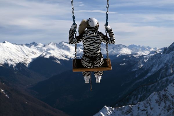 A tourist enjoys a swing ride in the Rosa Khutor ski resort in Sochi A tourist enjoys a swing ride in the Rosa Khutor ski resort in Sochi - Sputnik International