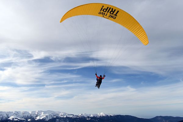 A person takes a paragliding ride in the 'Rosa Khutor' ski resort in Sochi A person takes a paragliding ride in the 'Rosa Khutor' ski resort in Sochi - Sputnik International