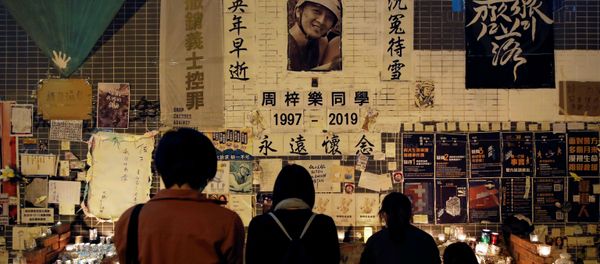 People gather near a makeshift memorial as they pay tribute to Chow Tsz-lok, 22, a university student who died two months ago after he fell from a car park during a protest, at Tseung Kwan O district in Hong Kong, China, January 8, 2020 - Sputnik International