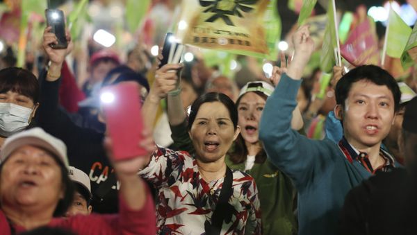 Supporters of Taiwan's 2020 presidential election candidate, Taiwan president Tsai Ing-wen of the Democratic Progressive Party (DPP), cheer during a campaign rally in Taipei, Taiwan, Friday, Jan. 10, 2020. Taiwan will hold its presidential election on Jan. 11, 2020. (AP Photo/Chiang Ying-ying) Supporters of Taiwan's 2020 presidential election candidate, Taiwan president Tsai Ing-wen of the Democratic Progressive Party (DPP), cheer during a campaign rally in Taipei, Taiwan, Friday, Jan. 10, 2020. Taiwan will hold its presidential election on Jan. 11, 2020. (AP Photo/Chiang Ying-ying) - Sputnik International