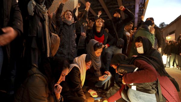 People gather for a candlelight vigil to remember the victims of the Ukraine plane crash, at the gate of Amri Kabir University, which some of the victims of the crash were former students of, in Tehran, Iran, on Saturday, 11 January 2020. On that day, Iran acknowledged that its armed forces unintentionally shot down the Ukrainian jetliner that crashed earlier this week, killing all 176 aboard, after the government had repeatedly denied Western accusations that it was responsible. - Sputnik International