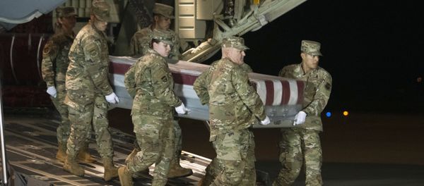 An Air Force carry team moves a transfer case containing the remains of Navy Ensign Joshua Watson on Sunday, Dec. 8, 2019, at Dover Air Force Base, Del. A Saudi gunman killed three people including 23-year-old Watson, a recent graduate of the U.S. Naval Academy from Enterprise, Ala., in a shooting at Naval Air Station Pensacola in Florida. - Sputnik International