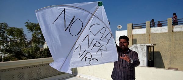 A man tries to fly a kite with a message, as part of a protest against a new citizenship law, on the occasion of kite flying festival, locally known as Uttarayan, in Ahmedabad, India, January 14, 2020 - Sputnik International