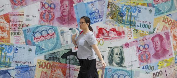 A woman walks by a money exchange shop decorated with different countries currency banknotes at Central, a business district in Hong Kong, Tuesday, Aug. 6, 2019 - Sputnik International