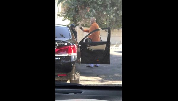 This man is pointing a gun to a guy on the motorbike for no reason near Zamzama Park  - Sputnik International