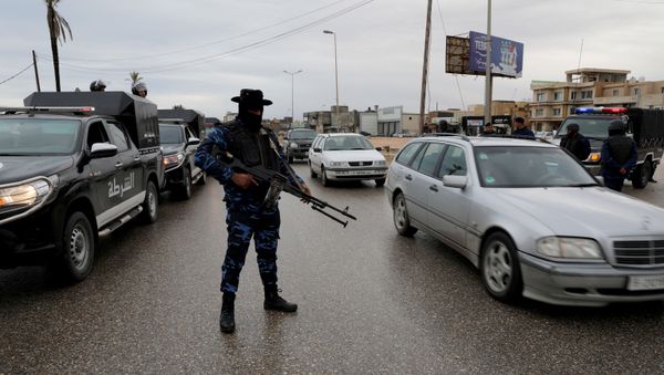A member of the central security support force holds a weapon during a security deployment in the Tajura neighborhood - Sputnik International