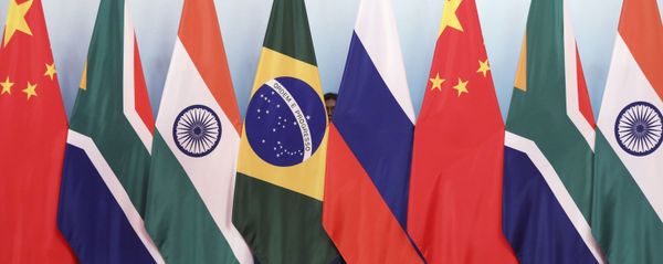 Staff worker stands behinds national flags of Brazil, Russia, China, South Africa and India to tidy the flags ahead of a group photo during the BRICS Summit at the Xiamen International Conference and Exhibition Center in Xiamen, southeastern China's Fujian Province, Monday, Sept. 4, 2017. Staff worker stands behinds national flags of Brazil, Russia, China, South Africa and India to tidy the flags ahead of a group photo during the BRICS Summit at the Xiamen International Conference and Exhibition Center in Xiamen, southeastern China's Fujian Province, Monday, Sept. 4, 2017. - Sputnik International