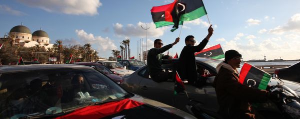 Libyans wave the national flag during commemorations to mark the second anniversary of the revolution that ousted Moammar Gadhafi in Benghazi, Libya, Friday, Feb, 15, 2013 Libyans wave the national flag during commemorations to mark the second anniversary of the revolution that ousted Moammar Gadhafi in Benghazi, Libya, Friday, Feb, 15, 2013 - Sputnik International