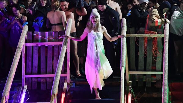 A woman prepares to take the plunge during celebrations for the Epiphany at the Izmailovo Kremlin in Moscow. - Sputnik International