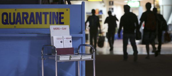 Passengers walk past the medical quarantine area showing information sheets for the Middle East respiratory syndrome coronavirus (File) - Sputnik International
