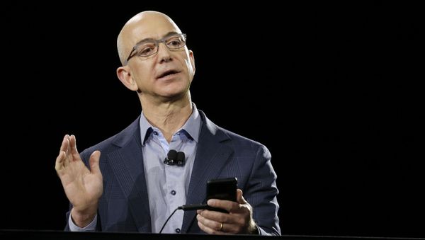 FILE - In a June 18, 2014 file photo, Amazon CEO Jeff Bezos demonstrates the new Amazon Fire Phone during a launch event, in Seattle. Blue Origin, LLC in Van Horn, Texas, the brainchild of Amazon founder Bezos, is one of two parts of the 21st-century space race being directed in the Texas by Internet billionaires FILE - In a June 18, 2014 file photo, Amazon CEO Jeff Bezos demonstrates the new Amazon Fire Phone during a launch event, in Seattle. Blue Origin, LLC in Van Horn, Texas, the brainchild of Amazon founder Bezos, is one of two parts of the 21st-century space race being directed in the Texas by Internet billionaires - Sputnik International